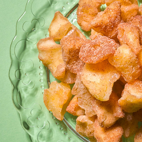 Apple pieces coated with cinnamon and sugar